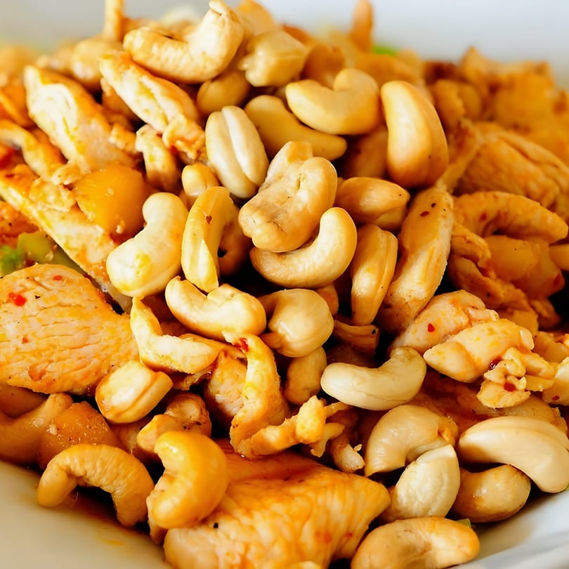 Close-up of Thai cashew chicken, featuring tender chicken pieces and whole cashews.